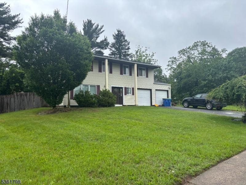 31 Patton Dr, Franklin Twp, NJ 08873 - view of front facade with asphalt driveway and a garage