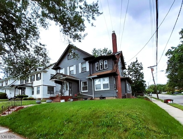 336 E 41st St, Paterson City, NJ 07504 - townhome / multi-family property featuring a chimney and a front yard