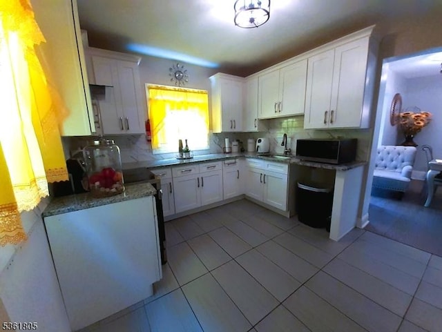336 E 41st St, Paterson City, NJ 07504 - kitchen with a sink, stainless steel microwave, and white cabinets