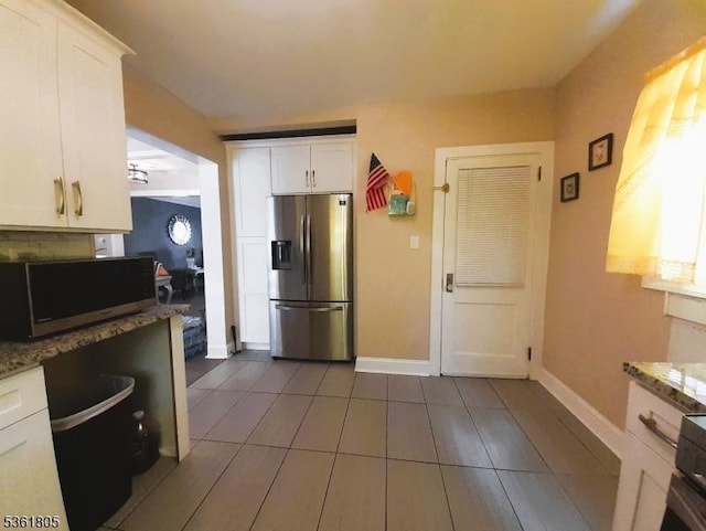336 E 41st St, Paterson City, NJ 07504 - kitchen featuring stainless steel appliances, white cabinetry, light stone countertops, and baseboards