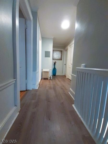 336 E 41st St, Paterson City, NJ 07504 - corridor featuring radiator heating unit and wood finished floors