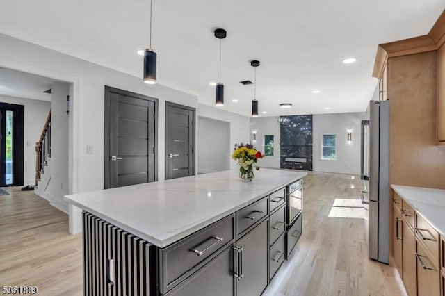 23 Meadow Ln, Sparta Twp, NJ 07871 - kitchen with light wood-style flooring, a center island, decorative light fixtures, recessed lighting, and freestanding refrigerator