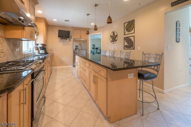 13 Van Saun Pl, Pequannock Twp, NJ 07444 - kitchen with under cabinet range hood, stainless steel appliances, a kitchen island, a kitchen bar, and recessed lighting