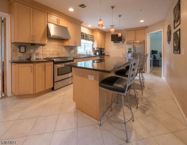 13 Van Saun Pl, Pequannock Twp, NJ 07444 - kitchen with stainless steel appliances, under cabinet range hood, a center island, dark countertops, and tasteful backsplash