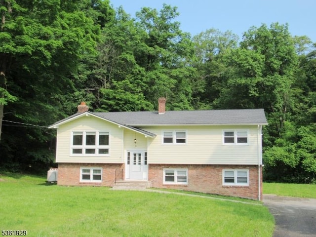 81 Sammis Rd, Vernon Twp, NJ 07461 - bi-level home featuring a chimney, a front lawn, and brick siding