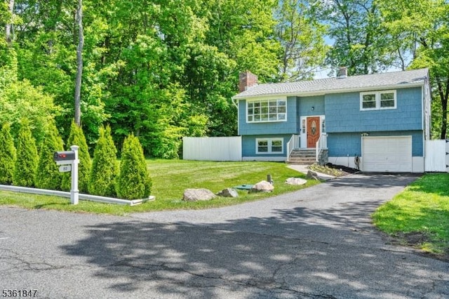 80 Cedar Tree Dr, Vernon Twp, NJ 07422 - bi-level home featuring a chimney, asphalt driveway, and an attached garage