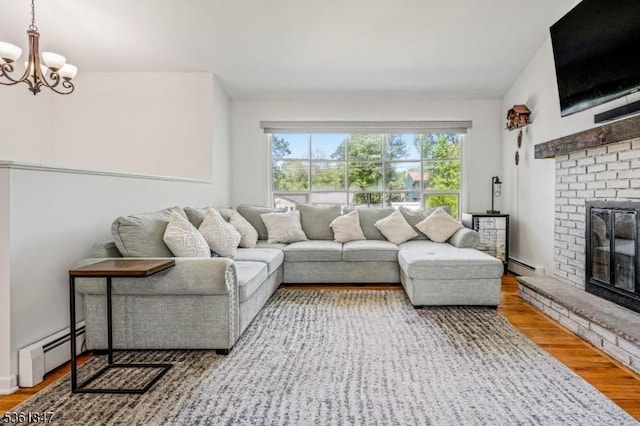 80 Cedar Tree Dr, Vernon Twp, NJ 07422 - living room featuring baseboard heating, a fireplace, a chandelier, and wood finished floors