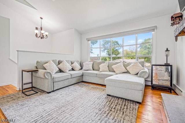 80 Cedar Tree Dr, Vernon Twp, NJ 07422 - living room featuring a baseboard heating unit, a chandelier, wood finished floors, vaulted ceiling, and baseboard heating