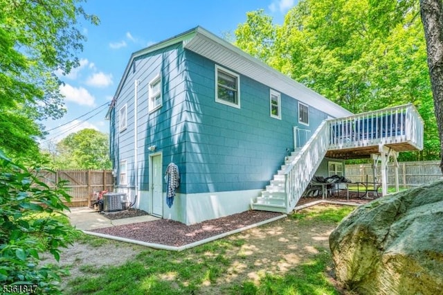 80 Cedar Tree Dr, Vernon Twp, NJ 07422 - rear view of property featuring stairs, a fenced backyard, a wooden deck, and central air condition unit