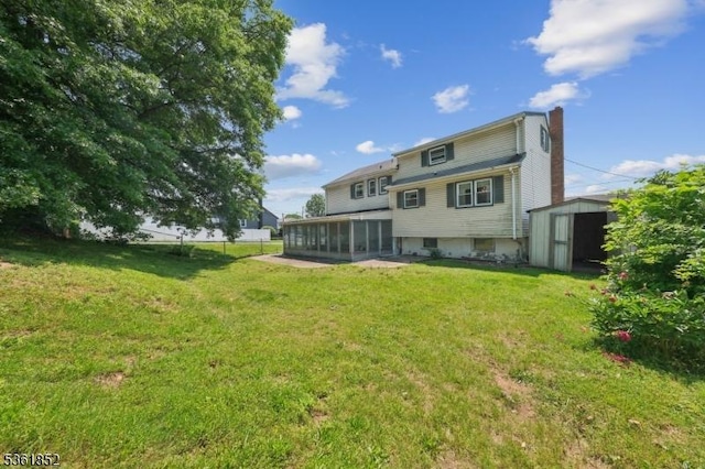 578 Winchester Ave, Union Twp, NJ 07083 - rear view of house with a sunroom, a chimney, and a lawn