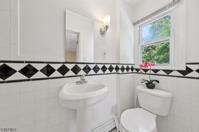 578 Winchester Ave, Union Twp, NJ 07083 - half bathroom with toilet, a baseboard heating unit, tile walls, and a wainscoted wall