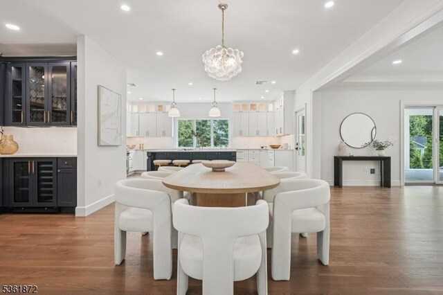 107 Rutland Rd, Glen Rock Boro, NJ 07452 - dining space with beverage cooler, plenty of natural light, dark wood-style floors, a chandelier, and recessed lighting