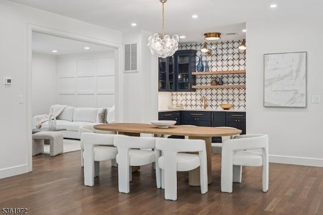 107 Rutland Rd, Glen Rock Boro, NJ 07452 - dining space with baseboards, dark wood-style floors, a chandelier, and recessed lighting