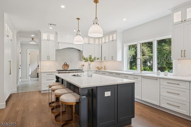 107 Rutland Rd, Glen Rock Boro, NJ 07452 - kitchen featuring a sink, light countertops, recessed lighting, a center island, and backsplash