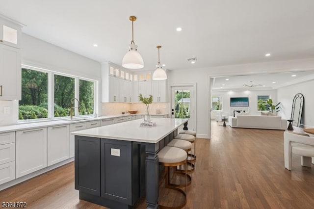 107 Rutland Rd, Glen Rock Boro, NJ 07452 - kitchen with a sink, white cabinetry, a kitchen island, light countertops, and dark wood-style floors