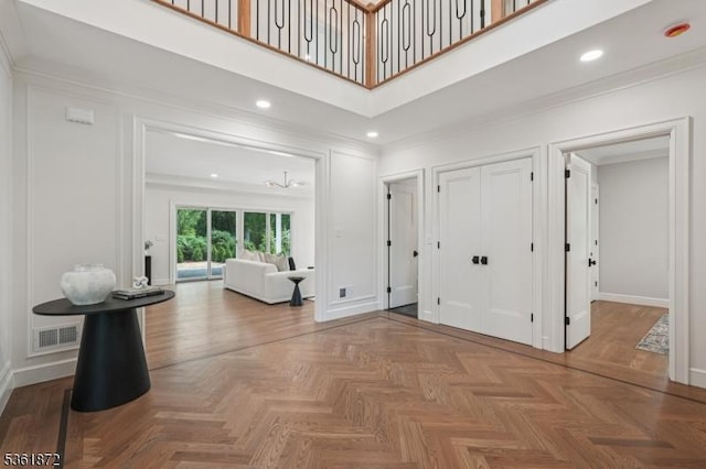 107 Rutland Rd, Glen Rock Boro, NJ 07452 - foyer entrance with baseboards, ornamental molding, and a towering ceiling