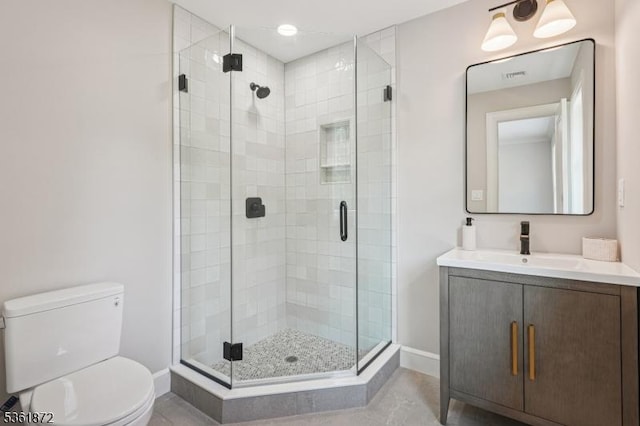 107 Rutland Rd, Glen Rock Boro, NJ 07452 - bathroom featuring toilet, vanity, baseboards, and a shower stall