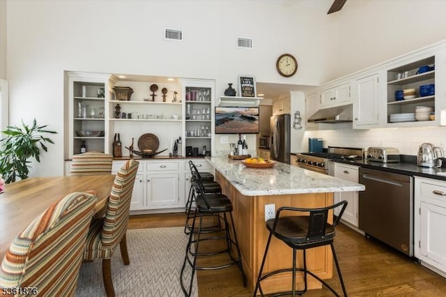 15 Yantecaw Ave, Bloomfield Twp, NJ 07003 - kitchen with open shelves, stainless steel appliances, under cabinet range hood, a towering ceiling, and a kitchen breakfast bar