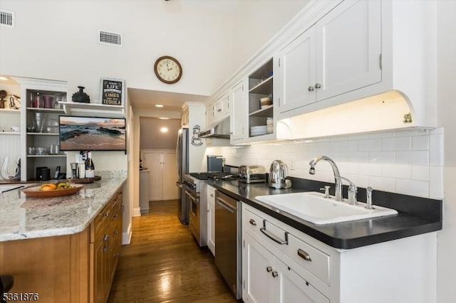 15 Yantecaw Ave, Bloomfield Twp, NJ 07003 - kitchen with appliances with stainless steel finishes, open shelves, tasteful backsplash, and dark wood-style floors