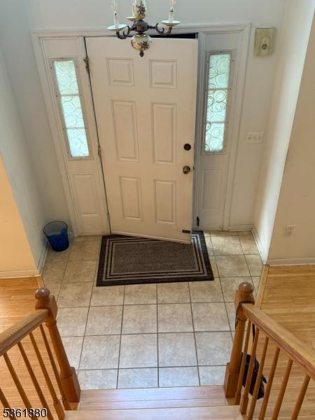 60 Forest Dr Unit 60, Piscataway Twp, NJ 08854 - entryway featuring a chandelier, light tile patterned floors, and plenty of natural light