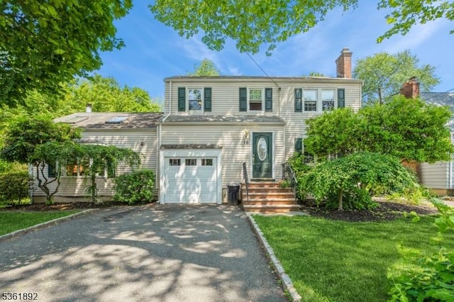 18 Mitchell Ave, Roseland Boro, NJ 07068 - view of front of property with driveway, a chimney, and a garage