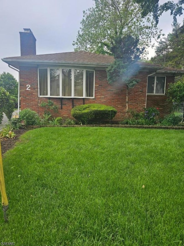 2 Crestview Ave Unit 1, Union Twp, NJ 07088 - view of front of property featuring brick siding, a front lawn, and a chimney