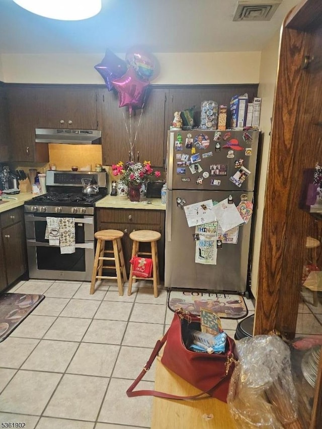 2 Crestview Ave Unit 1, Union Twp, NJ 07088 - kitchen featuring appliances with stainless steel finishes, light tile patterned floors, under cabinet range hood, and light countertops