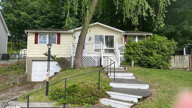 269 E Shore Trl, Sparta Twp, NJ 07871 - view of front facade featuring a garage, asphalt driveway, and covered porch