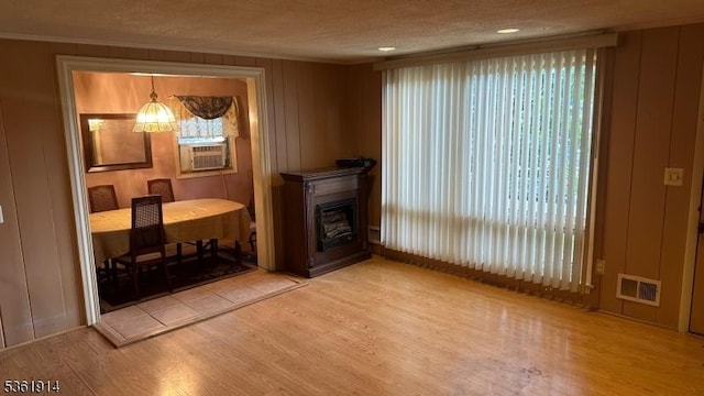 269 E Shore Trl, Sparta Twp, NJ 07871 - living room featuring light wood-style floors, cooling unit, ornamental molding, and a fireplace