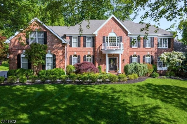 52 Independence Dr, Bernards Twp, NJ 07920 - colonial-style house featuring brick siding, a balcony, and a front yard