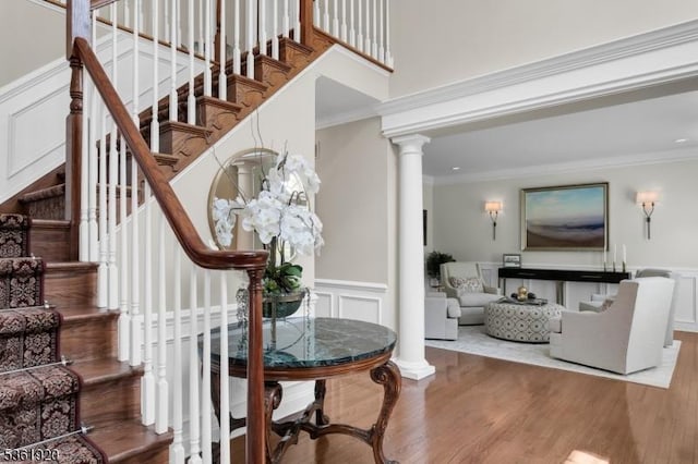 52 Independence Dr, Bernards Twp, NJ 07920 - stairway featuring a decorative wall, ornamental molding, wood finished floors, ornate columns, and a wainscoted wall