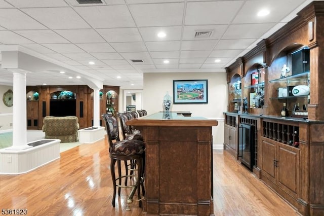 52 Independence Dr, Bernards Twp, NJ 07920 - bar with beverage cooler, ornate columns, light wood-type flooring, and recessed lighting