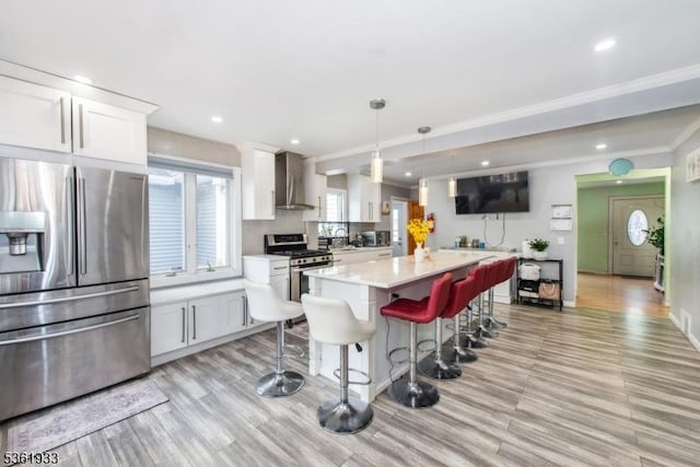 30 Filbert Ln, Union Twp, NJ 07083 - kitchen with appliances with stainless steel finishes, light countertops, light wood-style floors, wall chimney range hood, and white cabinets