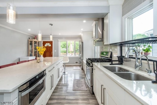 30 Filbert Ln, Union Twp, NJ 07083 - kitchen with appliances with stainless steel finishes, a sink, crown molding, white cabinets, and wood finished floors
