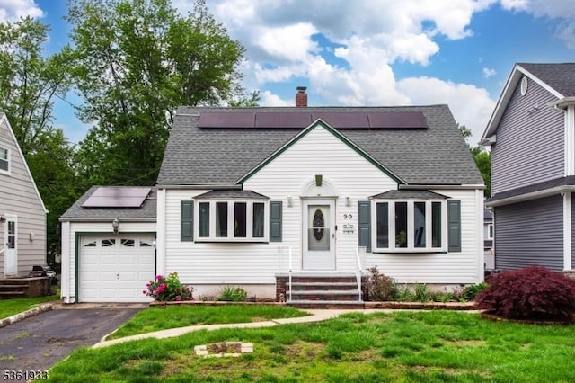 30 Filbert Ln, Union Twp, NJ 07083 - view of front of house featuring solar panels, an attached garage, asphalt driveway, a chimney, and entry steps