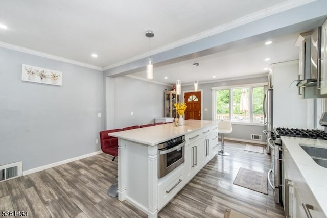 30 Filbert Ln, Union Twp, NJ 07083 - kitchen featuring wood finished floors, baseboards, stainless steel appliances, white cabinetry, and crown molding