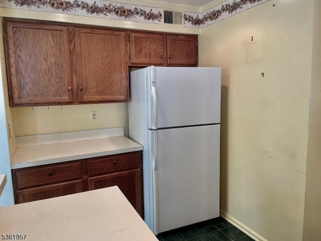 55 Weatherhill Rd, Hamburg Boro, NJ 07419 - kitchen featuring freestanding refrigerator, light countertops, brown cabinetry, and dark tile patterned floors