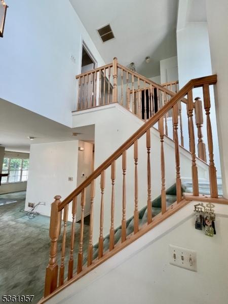 55 Weatherhill Rd, Hamburg Boro, NJ 07419 - staircase with a towering ceiling and carpet