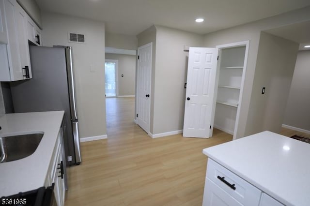 914 Merritt Dr Unit E, Hillsborough Twp, NJ 08844 - kitchen featuring light wood-style flooring, baseboards, recessed lighting, and light countertops