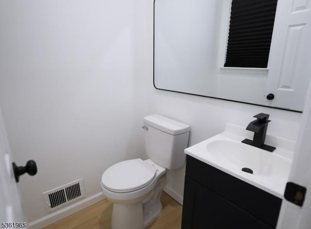 914 Merritt Dr Unit E, Hillsborough Twp, NJ 08844 - half bathroom with vanity, toilet, baseboards, and wood finished floors