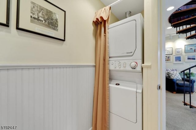 111 Mulberry St Unit Sky, Newark City, NJ 07102 - laundry room featuring stacked washing machine and dryer, wainscoting, and carpet flooring