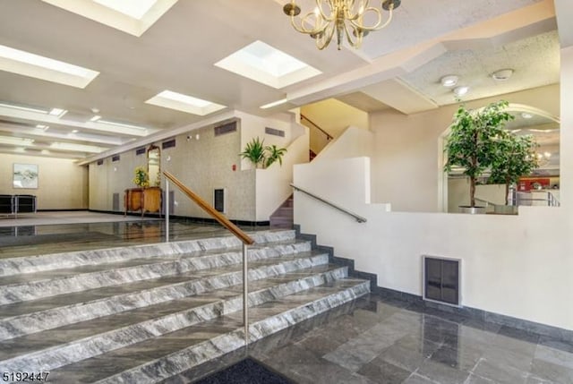 111 Mulberry St Unit Sky, Newark City, NJ 07102 - stairs with a chandelier, a skylight, and marble finish flooring