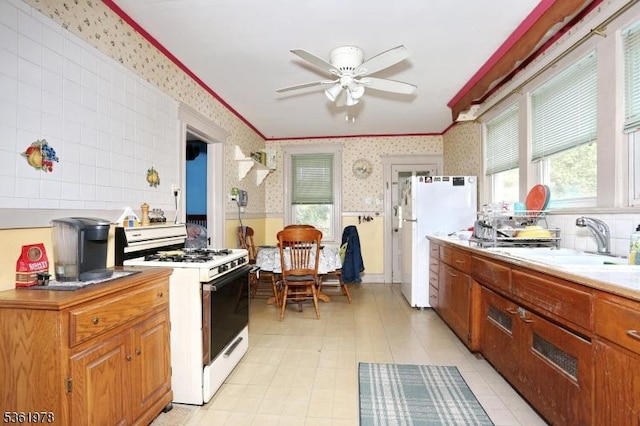 267 Hoover Ave, Bloomfield Twp, NJ 07003 - kitchen featuring white appliances, wallpapered walls, plenty of natural light, a sink, and a ceiling fan