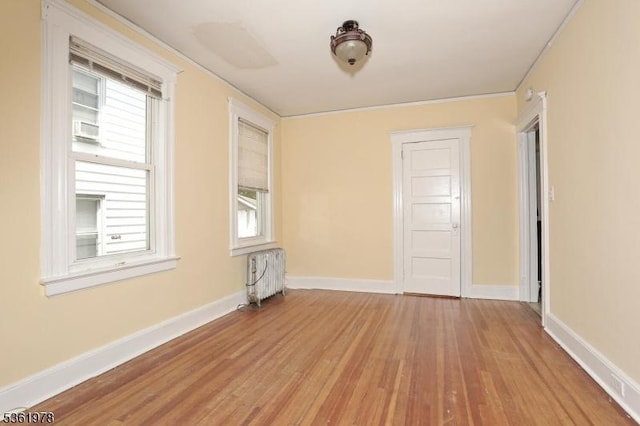 267 Hoover Ave, Bloomfield Twp, NJ 07003 - empty room with radiator, wood finished floors, plenty of natural light, baseboards, and ornamental molding