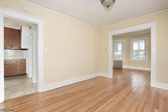 267 Hoover Ave, Bloomfield Twp, NJ 07003 - spare room featuring ornamental molding, baseboards, light wood-type flooring, and radiator