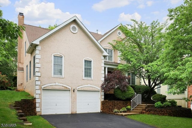 7 Watchung Dr, Bernards Twp, NJ 07920 - view of front of home featuring an attached garage, asphalt driveway, a chimney, and stucco siding