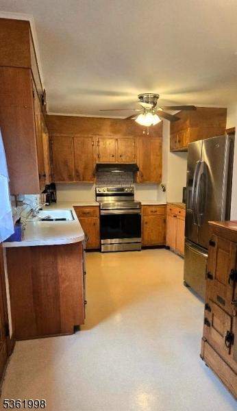 355 State Route 94, Fredon Twp, NJ 07860 - kitchen with stainless steel appliances, under cabinet range hood, ceiling fan, brown cabinets, and light countertops