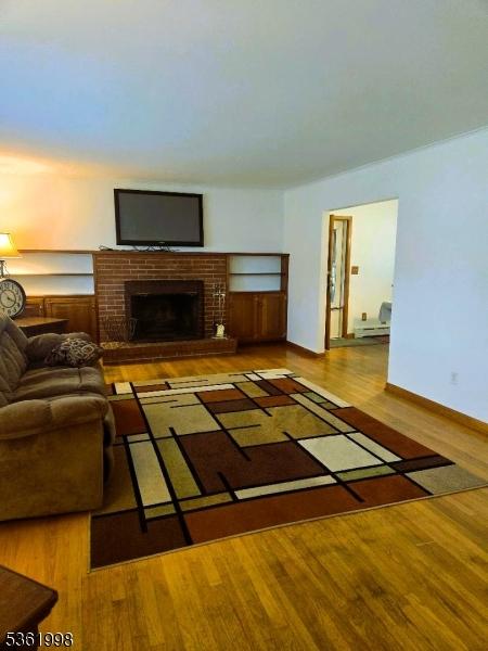 355 State Route 94, Fredon Twp, NJ 07860 - living room with wood finished floors and a brick fireplace
