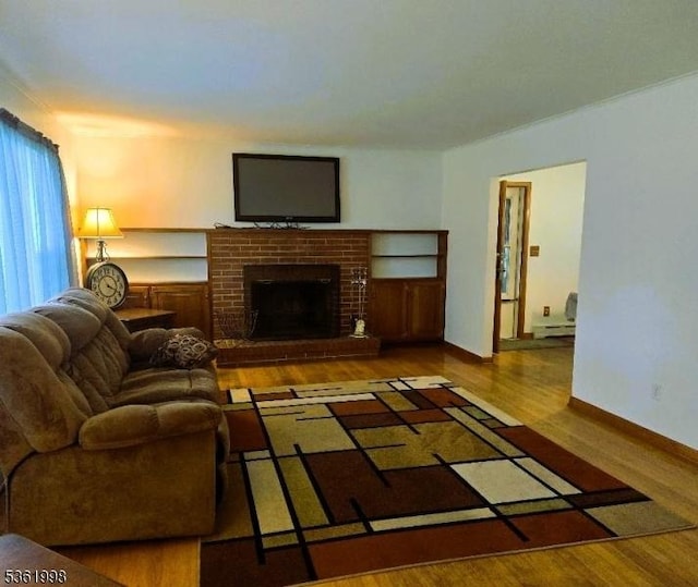 355 State Route 94, Fredon Twp, NJ 07860 - living area with wood finished floors, a baseboard radiator, and a brick fireplace