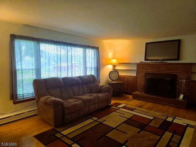 355 State Route 94, Fredon Twp, NJ 07860 - living area with a baseboard heating unit, wood finished floors, and a brick fireplace